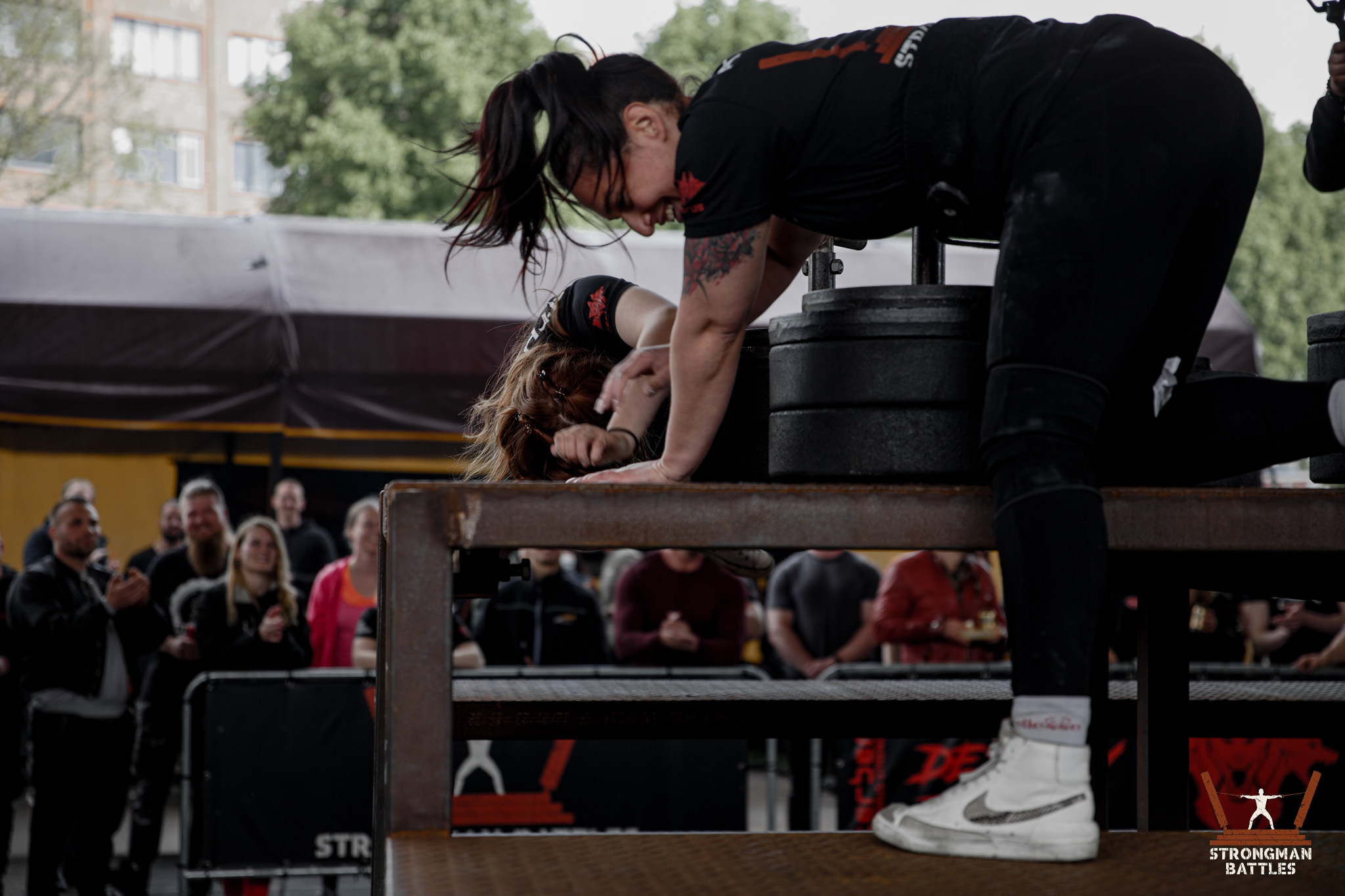 Two crew members preparing the stone loading platform during Strongman Battles